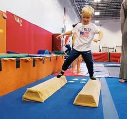 Child practicing balance in Mismo gymnastics programs