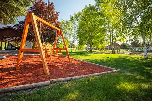 A picture of a bench swing located adjacent to the mini-golf course