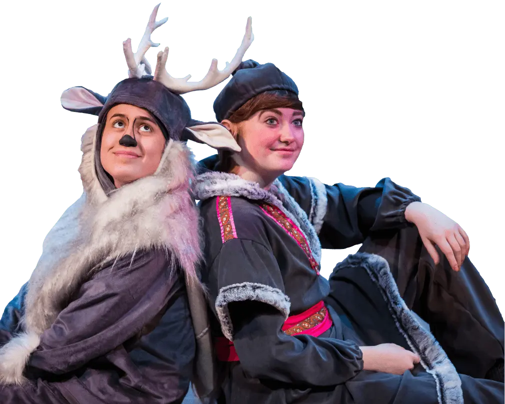 Two actors in costume pose back-to-back as part of a stage performance.