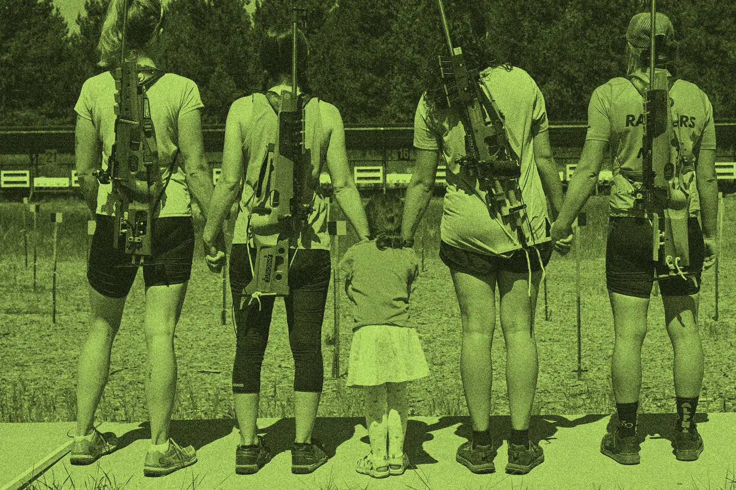 Four people, including a small child, stand holding hands with rifles on their backs at a shooting range.