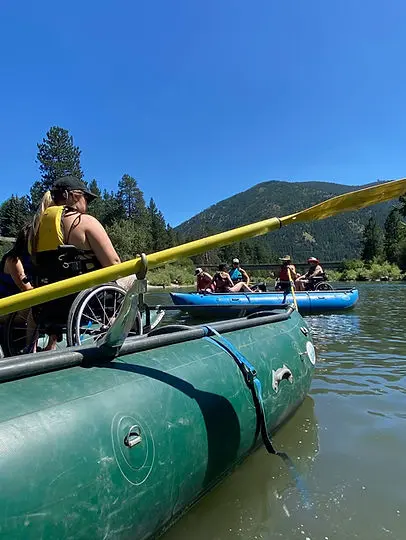 Back of raft with wheelchair user on a sunny day
