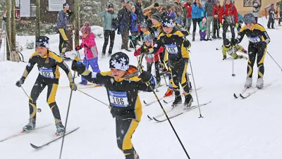 Photo from seeleylakenordic.org A group of children compete in a cross-country ski race during a snowfall.