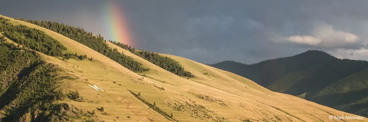Mount Sentinel and the M trail with a rainbow behind the mountain