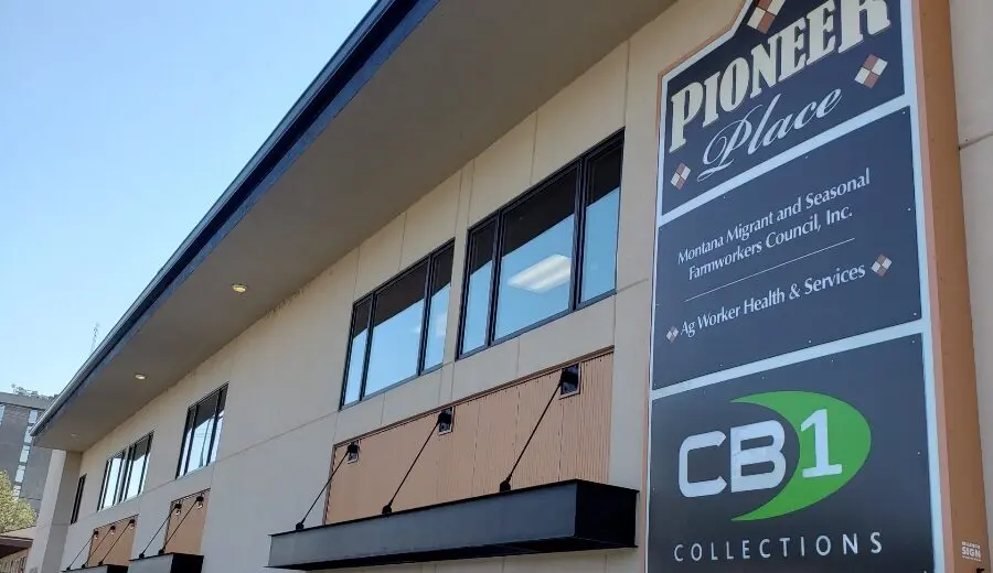 A photograph shows the exterior of a commercial building with signage identifying its occupants.