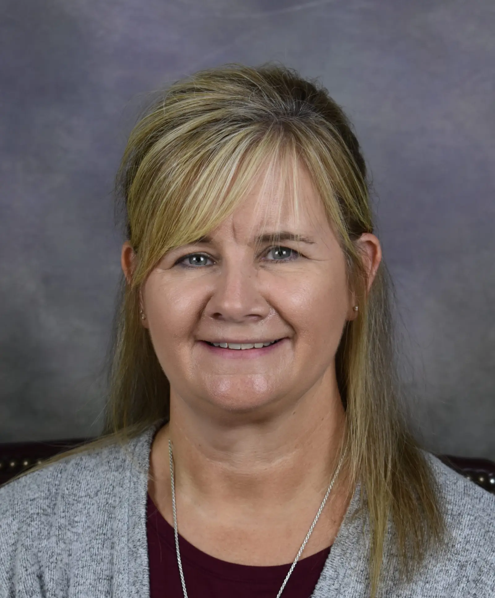 A professional portrait of a smiling woman.
