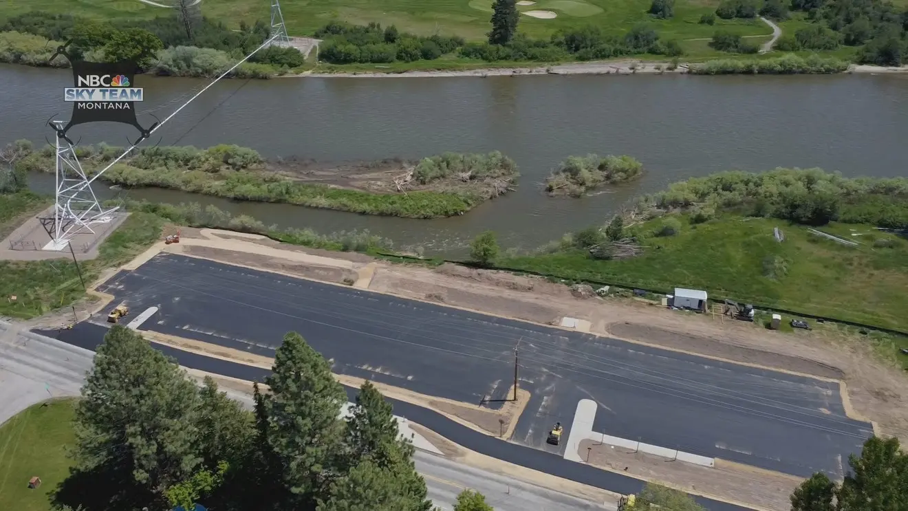 An aerial view shows a construction site next to a river.