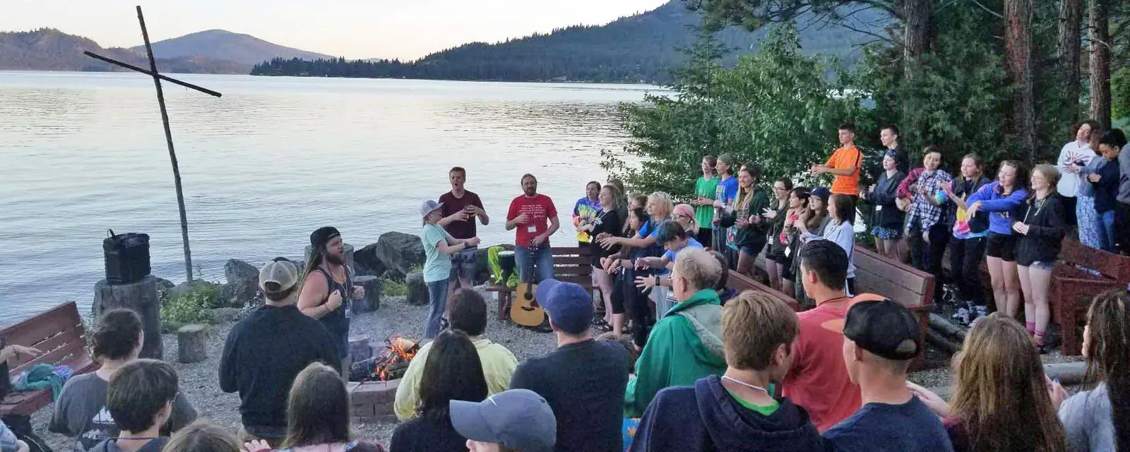 Senior High campers meeting at the cross by the lake