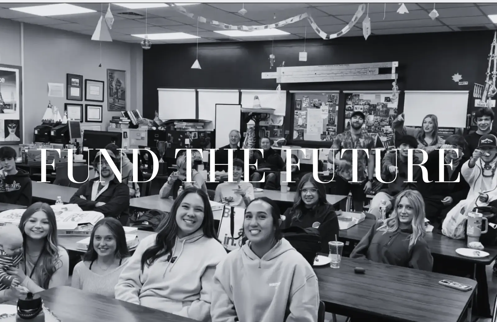 A group of students sits in a classroom with the text "FUND THE FUTURE" overlaid on the image.