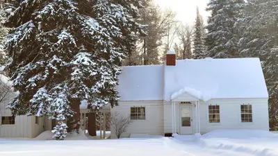 Photo from fs.usda.gov Image of the East Cottage at Savenac in the wintertime, Lolo National Forest, Montana.