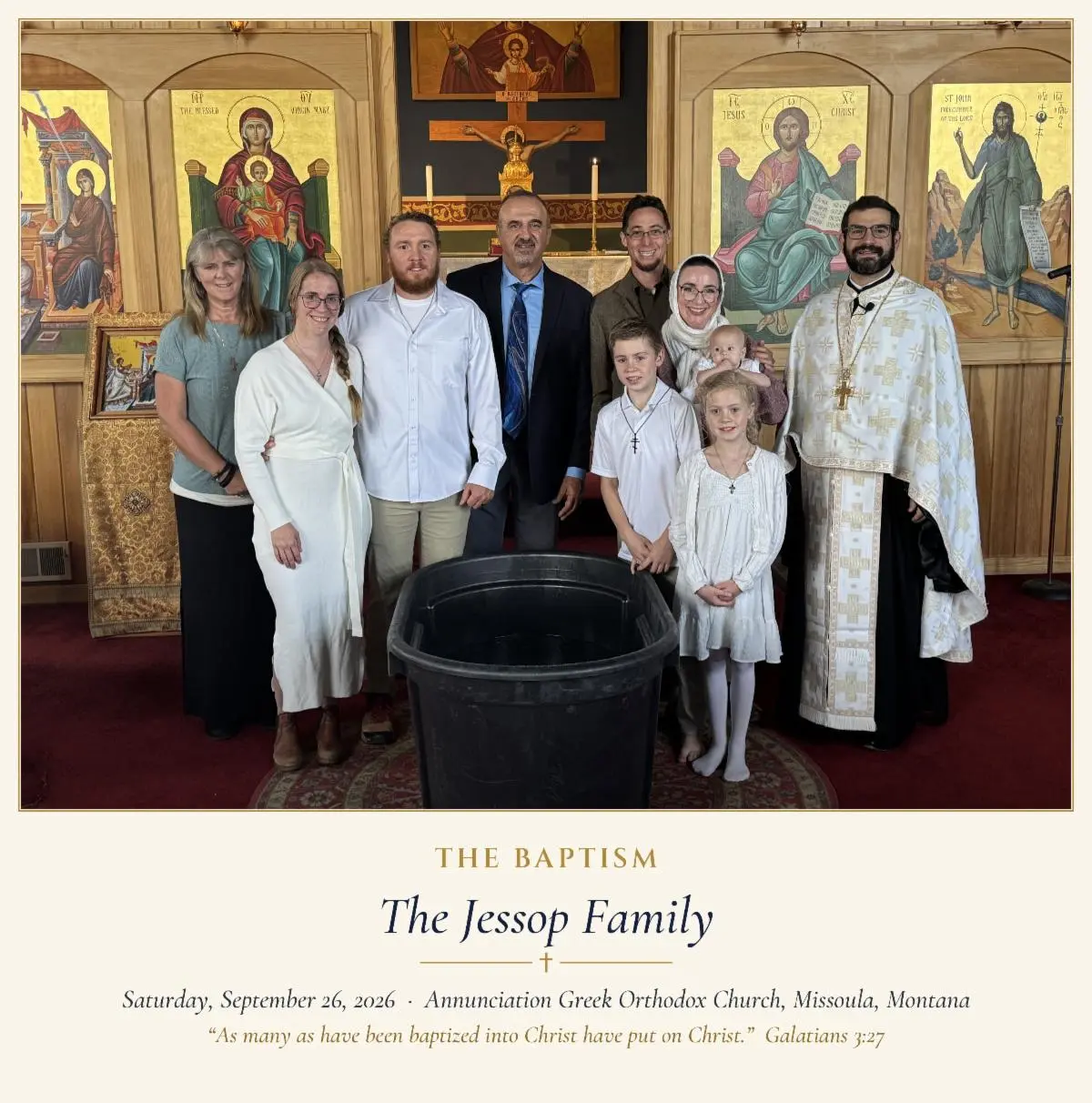 A group stands before a baptismal font inside a church.