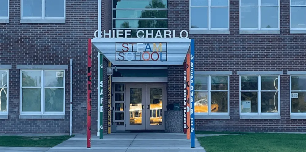 Front entrance of Chief Charlo school building with colorful pillars with different words on them