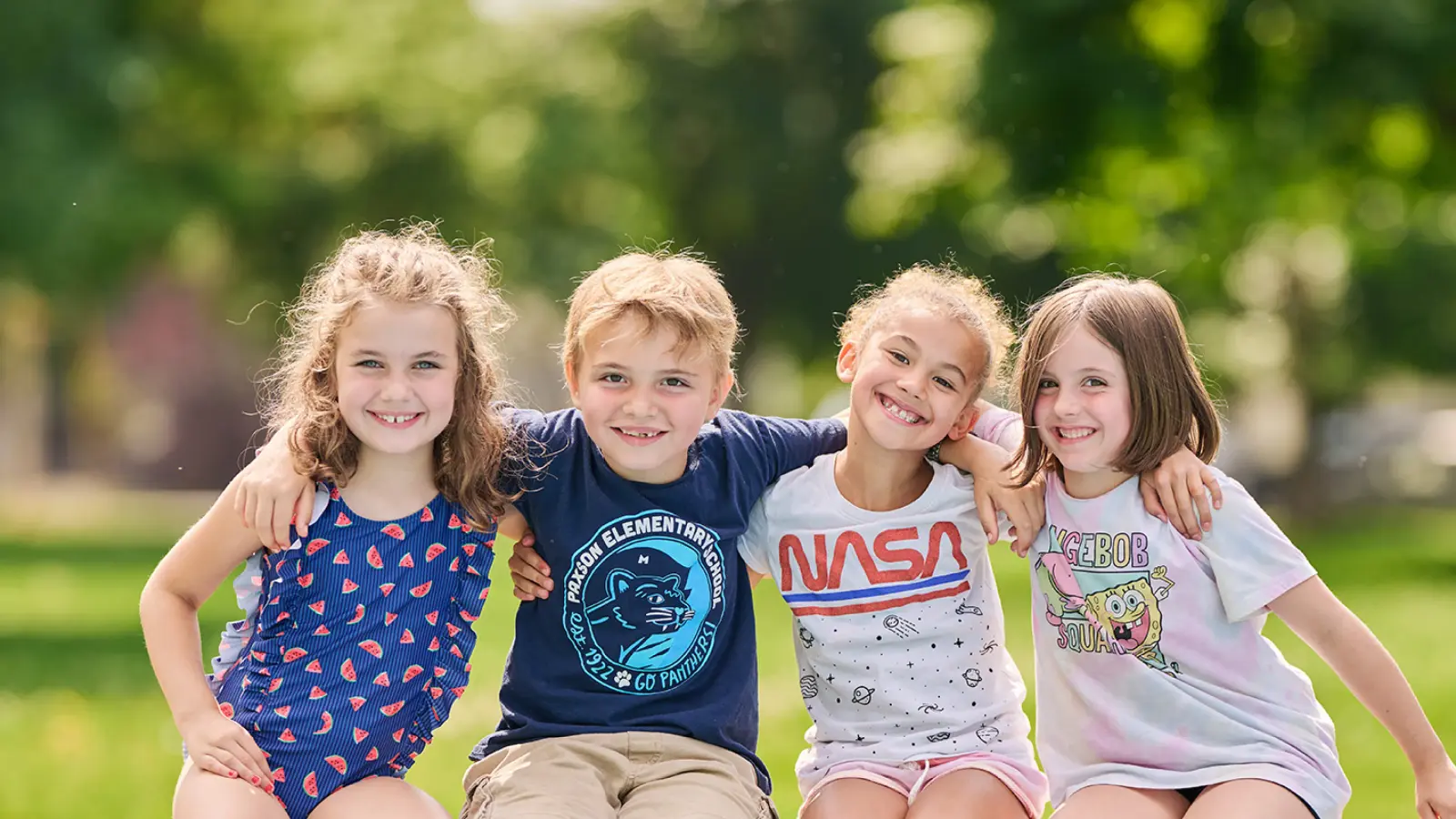 five children with their arms around each others' shoulders at missoula ymca summer camp
