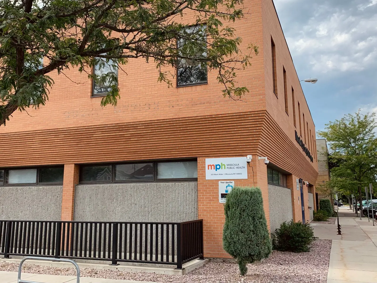 A brick building houses a public health office.