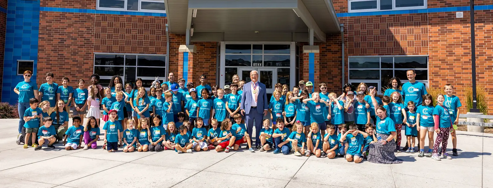 Arlyne Simon, inventor and former Collegiate Inventors Competition Finalist, smiles with a group of Camp Invention campers