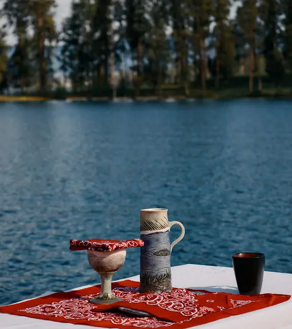 The sacraments rest on an altar on the dock of Camp Marshall, with Flathead Lake and Dream Island in the background