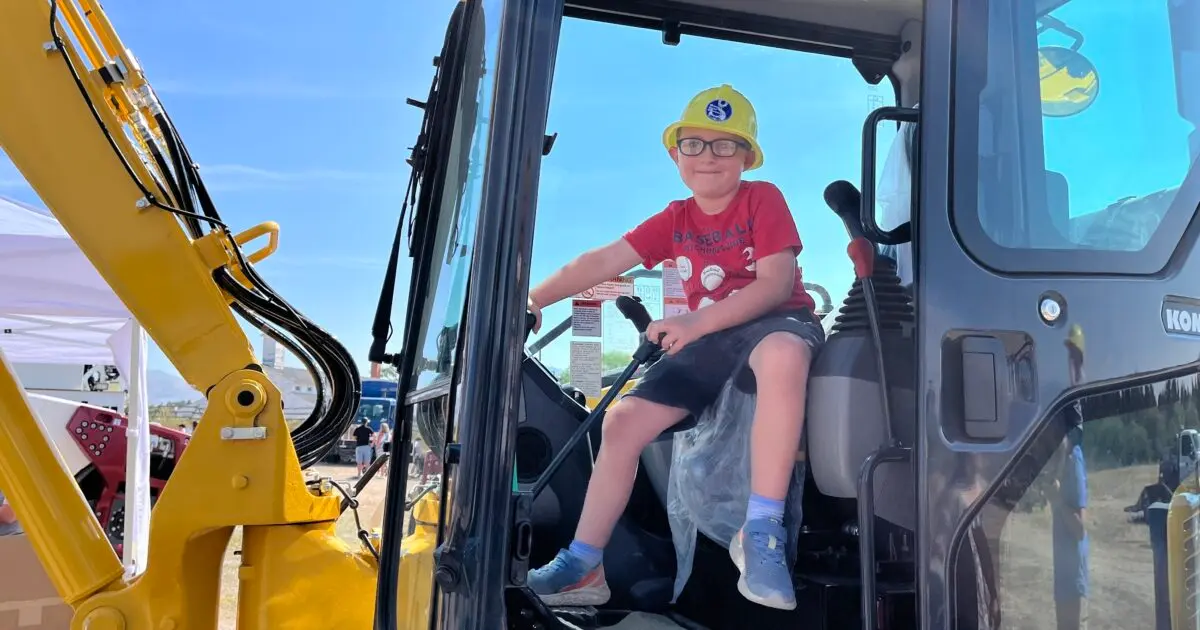 Kid sitting in a bulldozer at Missoula Under Construction.