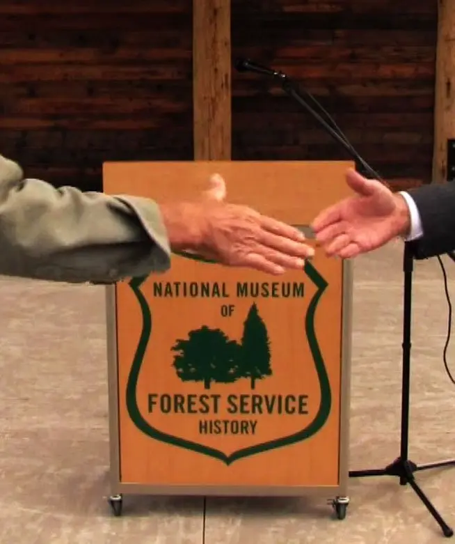 Two men shaking hands at an event at the National Museum of Forest Service.
