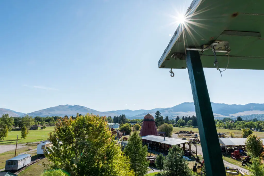 A view of a landscape with mountains in the background and a building structure in the foreground.