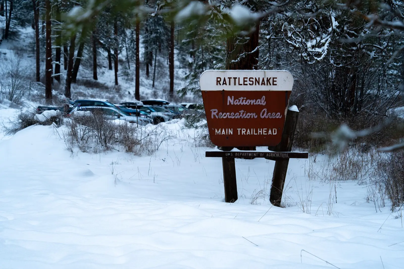 Image of the sign to the Rattlesnake National Recreation Area main trailhead in the winter.