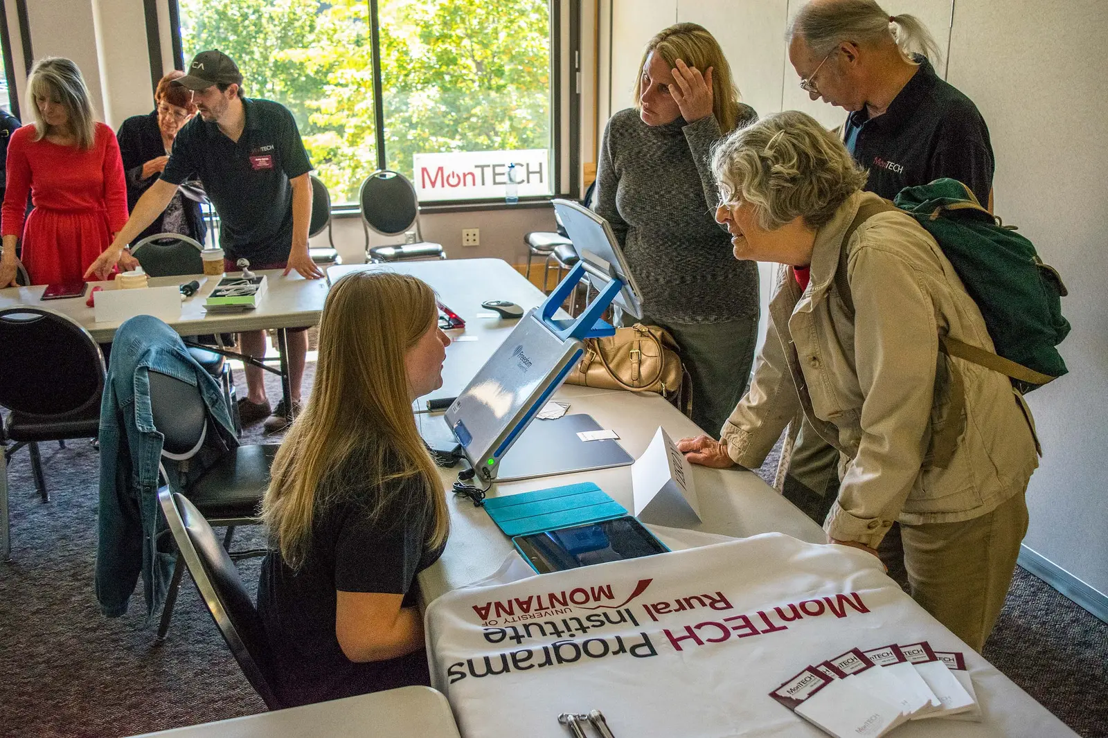 montech staff talking to people at information table