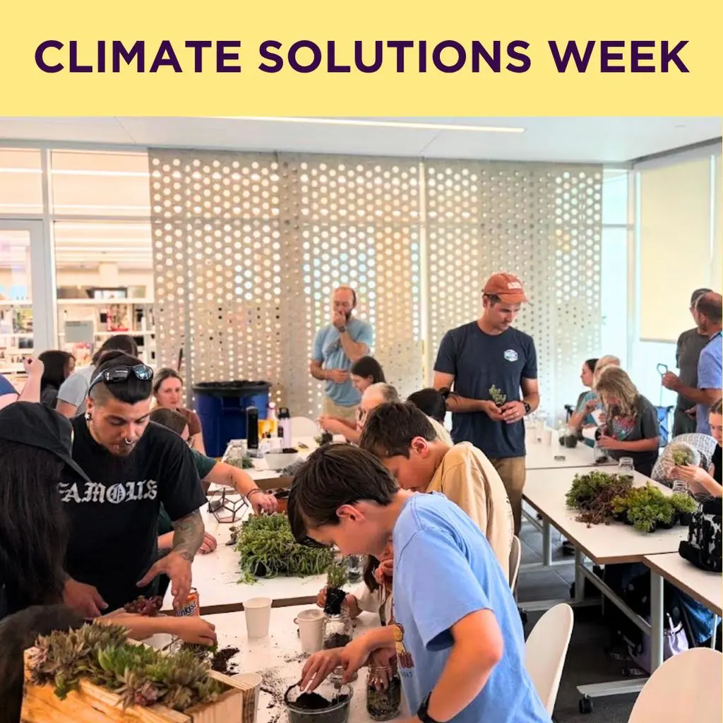 A diverse group of people works on a plant-based craft project during an event called Climate Solutions Week.
