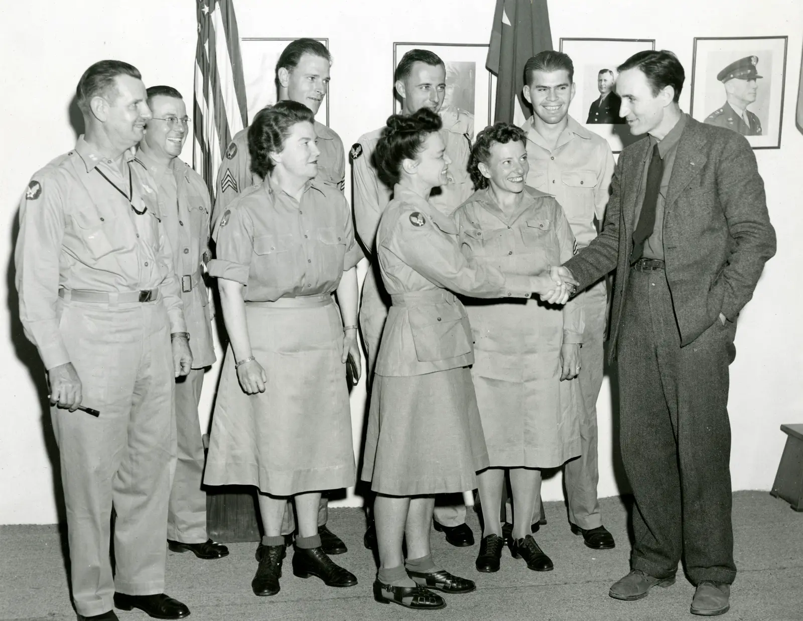 This is a photo of Mike Mansfield shaking hands with some Military folks