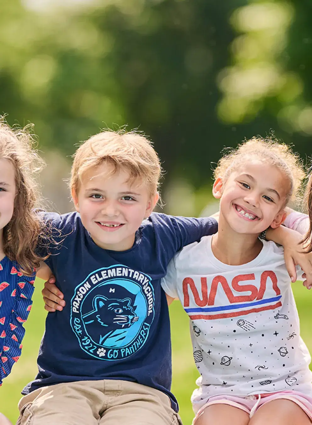 five children with their arms around each others' shoulders at missoula ymca summer camp