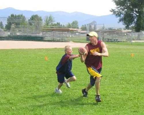 Kids Playing Football with Coaches at Missoula Hall of Fame Sports Academy