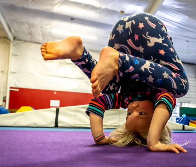 Preschool Child doing headstand