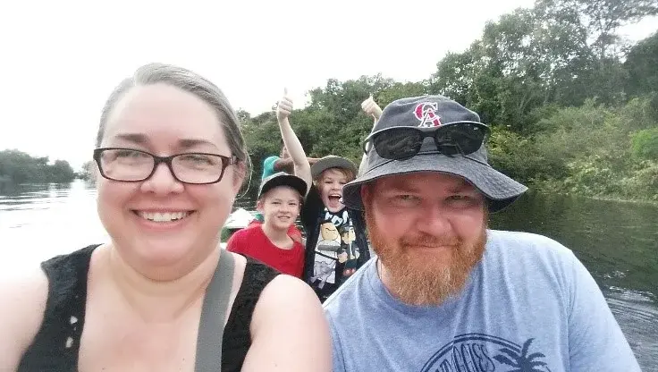 A family takes a selfie while on a boat trip.