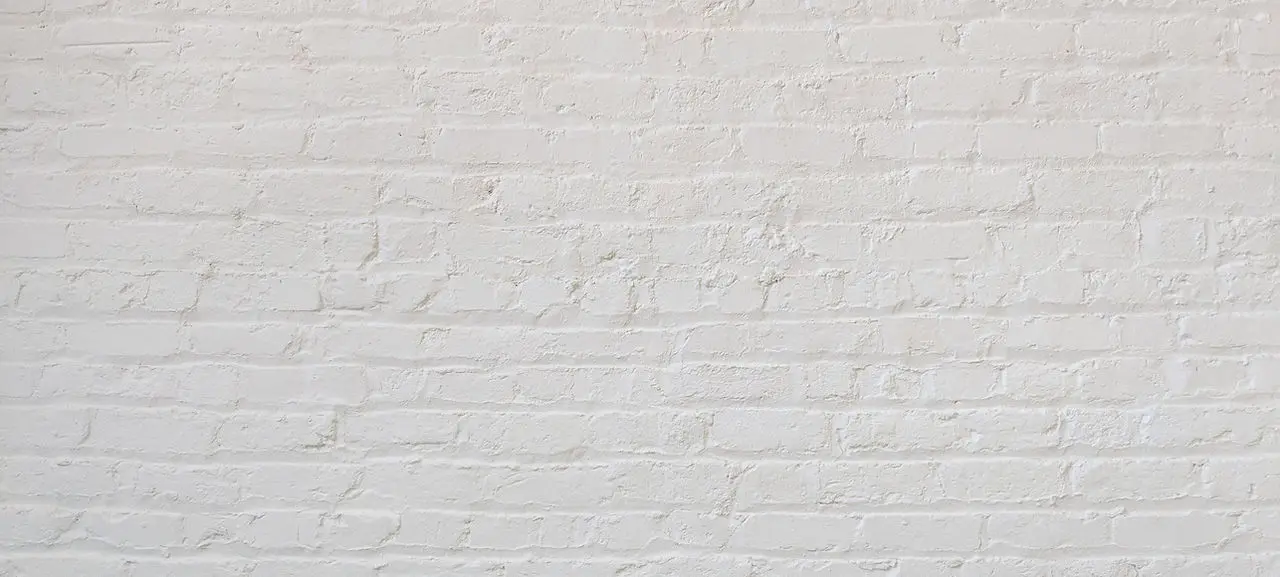 A wall made of white-painted bricks.