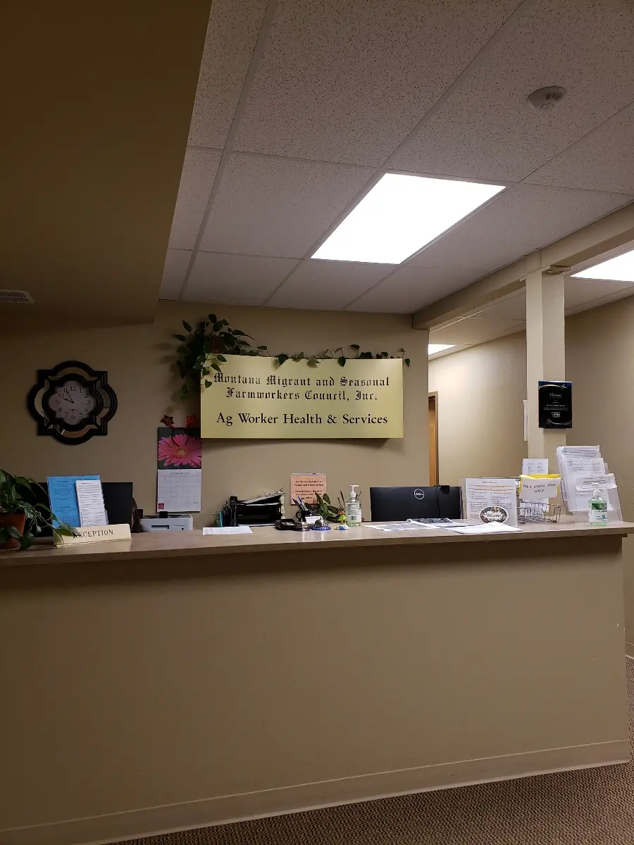 A reception desk area is shown with a sign naming the organization.