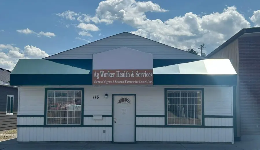 The front exterior of a building with a sign that identifies it as Ag Worker Health & Services.