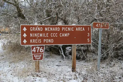 Photo by Djembayz, CC BY-SA 4.0 File:Sign for 476 National Forest Road - Grand Menard Picnic Area - Ninemile CCC Camp.jpg