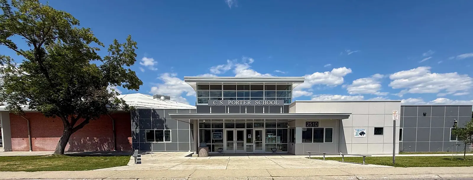 A school building exterior under a clear blue sky.