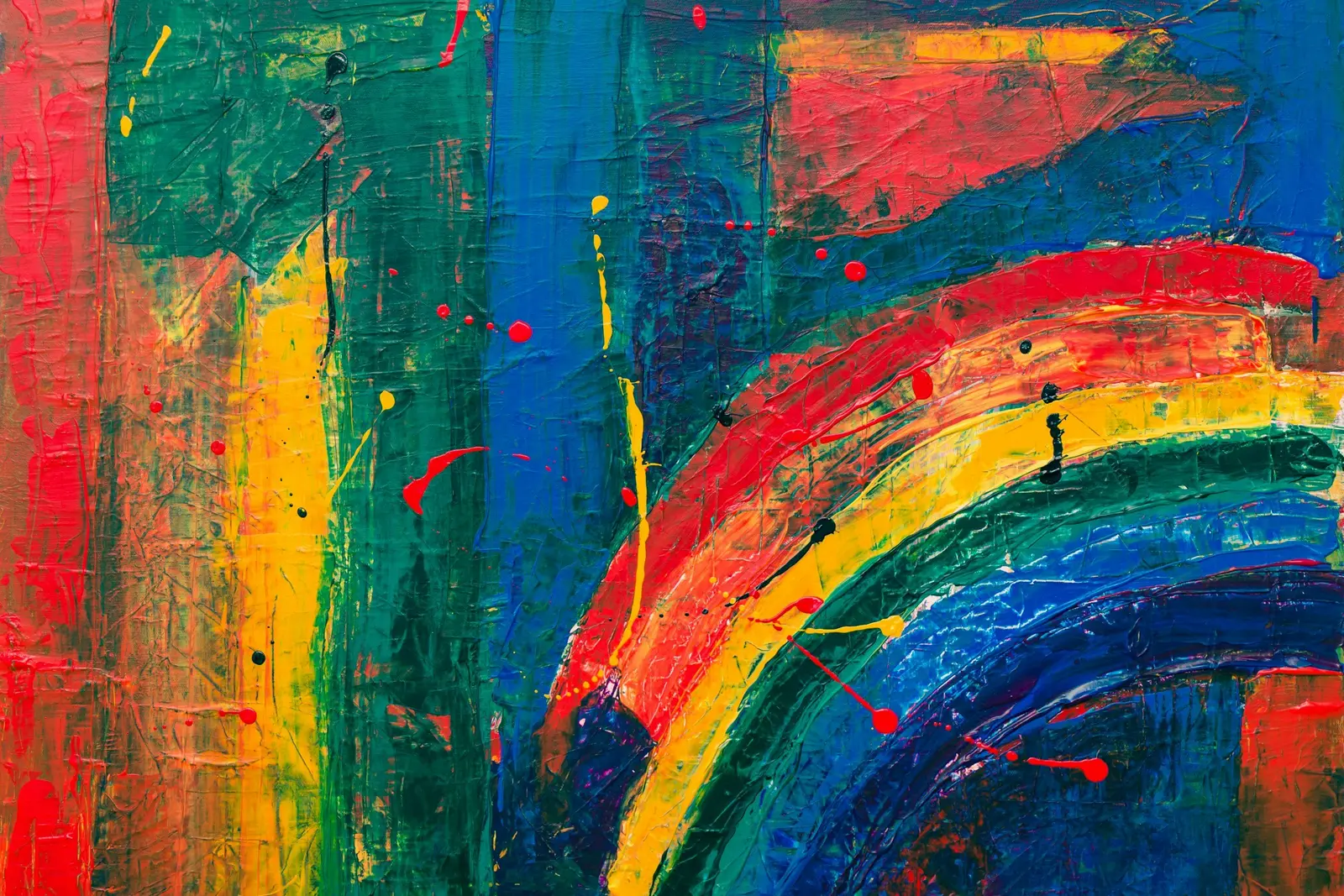 A vibrant abstract painting features textured brushstrokes and paint splatters in red, yellow, green, and blue.