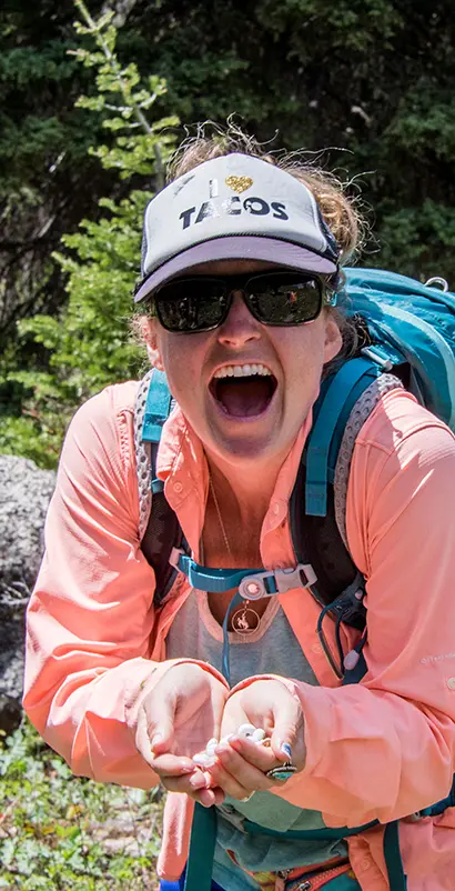 Female staff member laughing with taco hat on