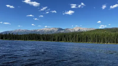 Photo from recreation.gov A photo of Lake Alva on a sunny day. The water and skies are bright blue, and trees and the swan range can be seen in the background.