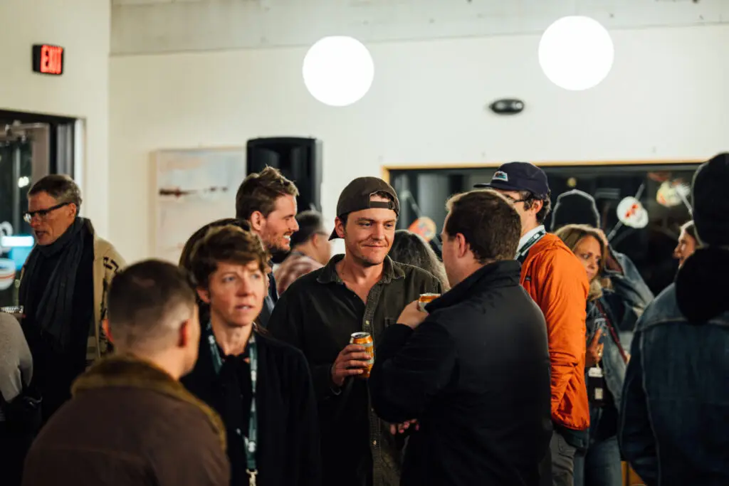 A group of adults socializing indoors at an event.